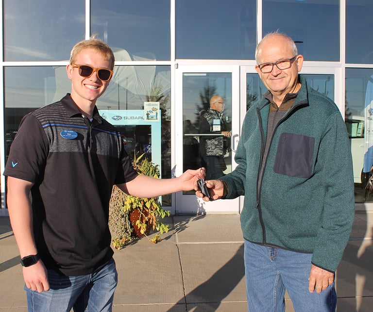 Ethan hands Dan his new car keys.